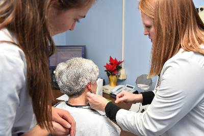 audiologists working with patient