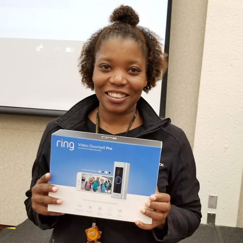 Lady with a prize she won at the Tech Fair