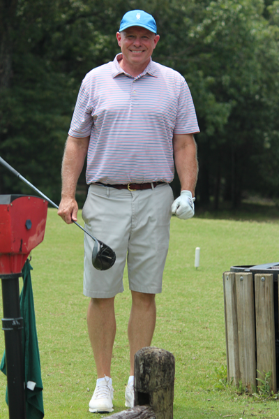 Program Director with a golf club on the golf course