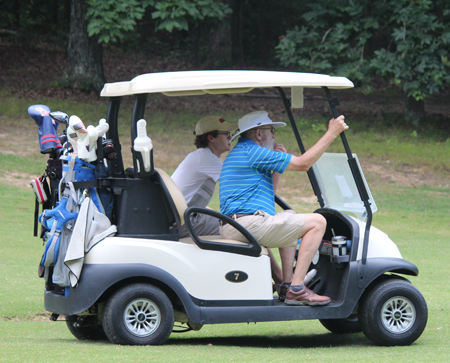Resident and faculty members in a golf cart