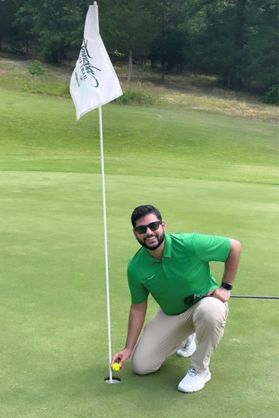 Resident at a golf tee with a flag