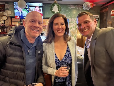 three faculty smiling for the camera at the holiday party