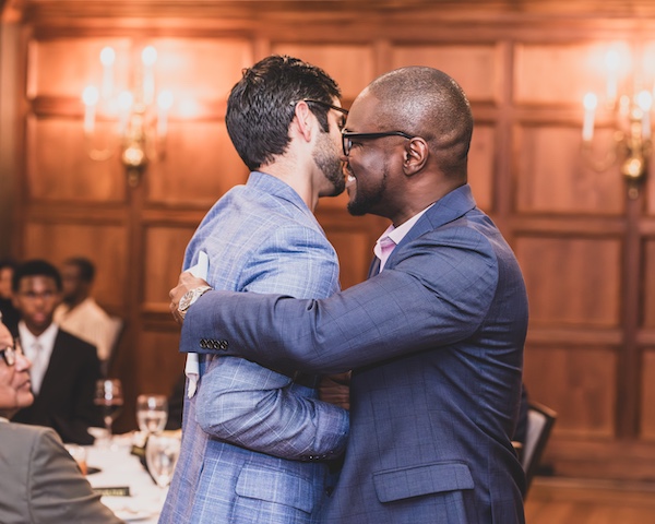 Fellows hugging during graduation