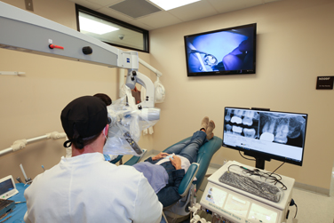 Endodontist working at the Endodontics clinic on a patient.