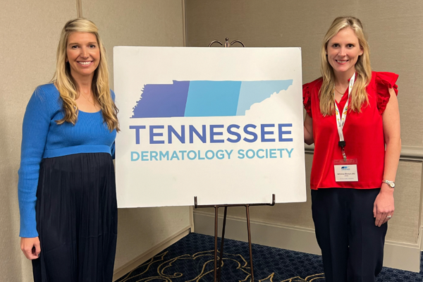 Residents before a TN Dermatology Society sign