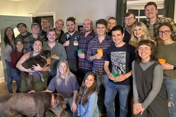 Residents in a home posing with dogs