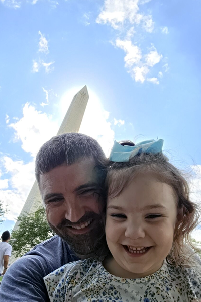 Male resident and his daughter in front of the Washington monument