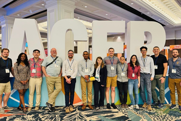 Residents posing inside at a conference