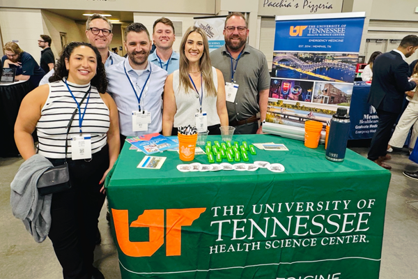 Residents and faculty at the UTHSC table at a conference