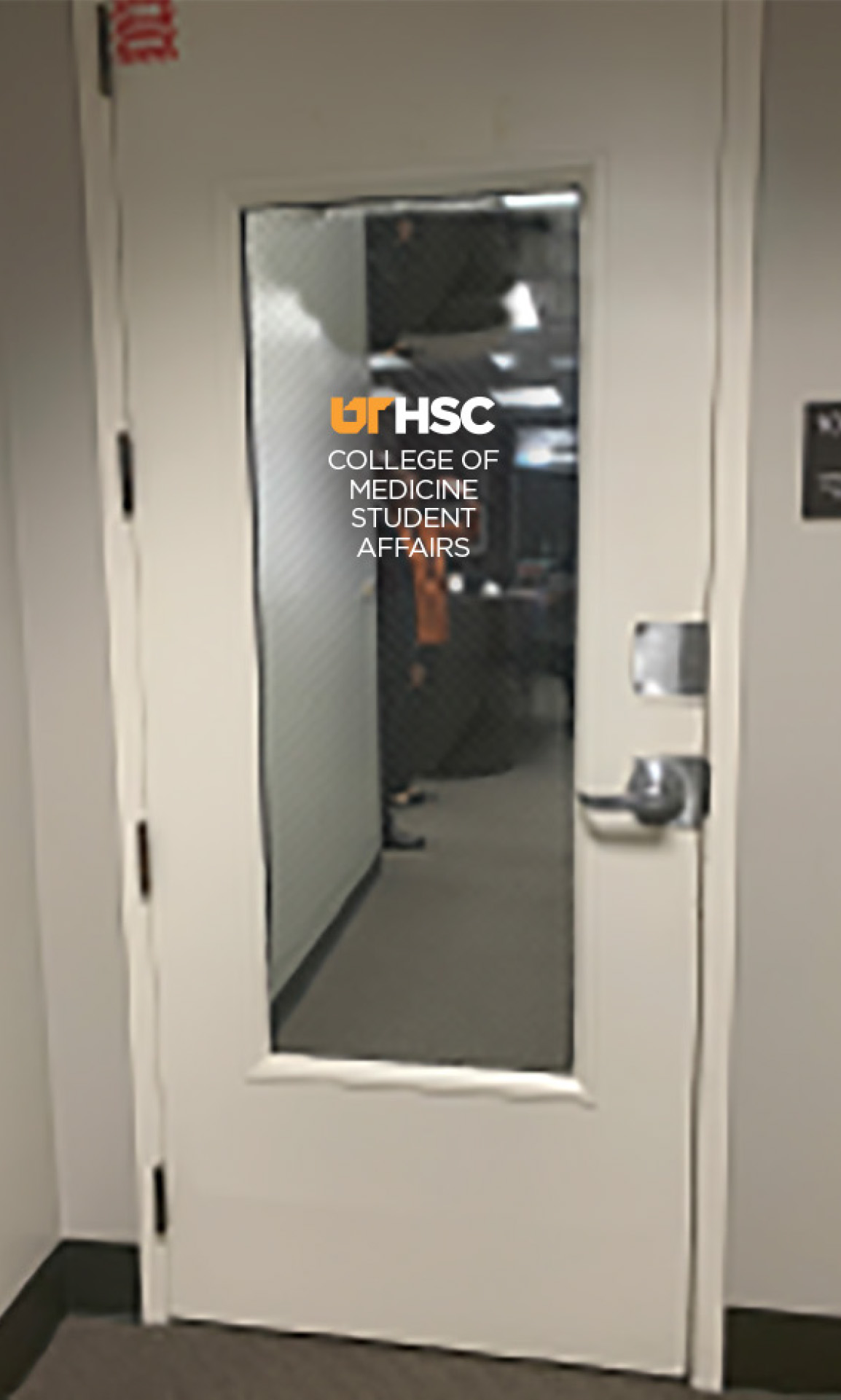 Example of white sign on a glass entrance.