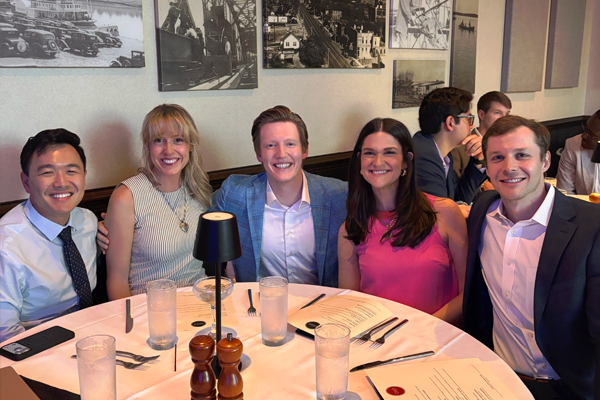 Group of fellows sitting at the dinner table at the 2026 graduation venue