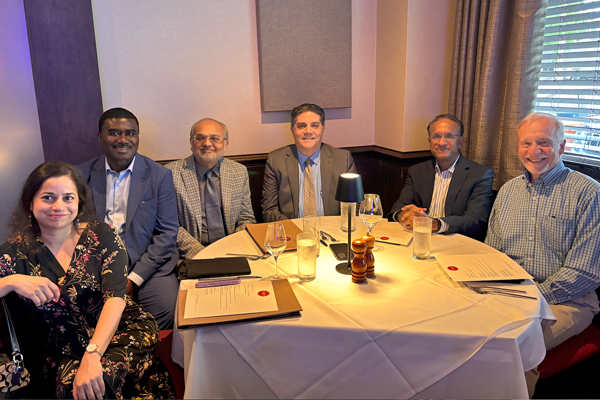 Group of faculty sitting at the dinner table at the 2026 graduation venue