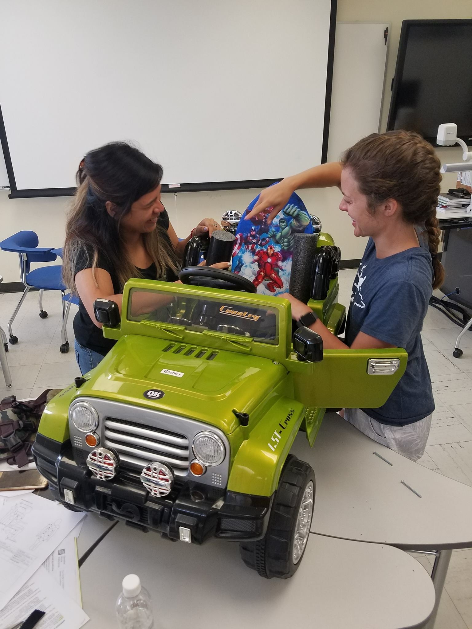 Two students customize a car for Go Baby Go