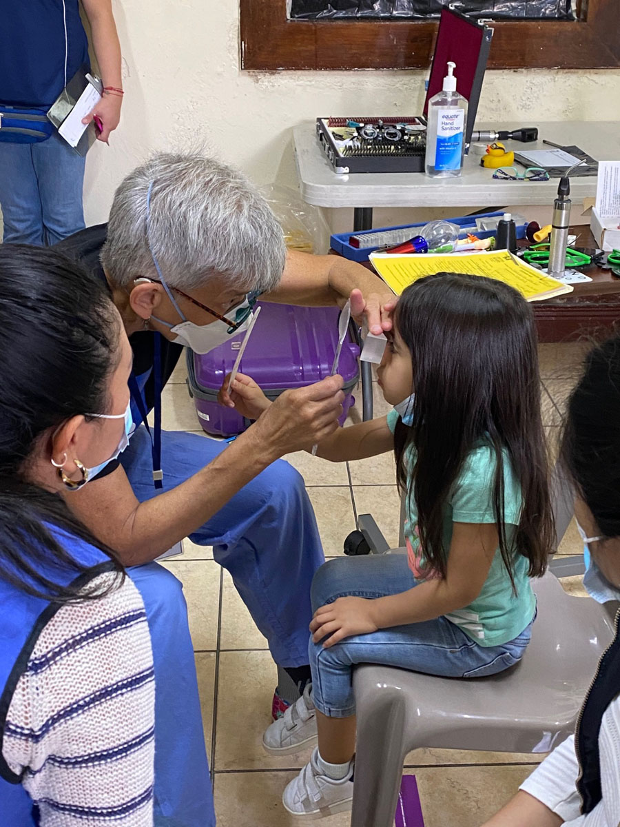 Doctor examing child's eye.