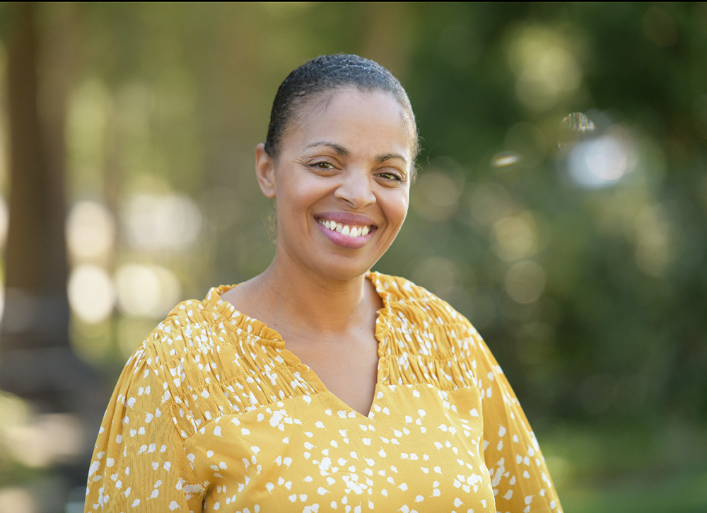 Dr. Mega Burkhardt-Reed smiling outside.