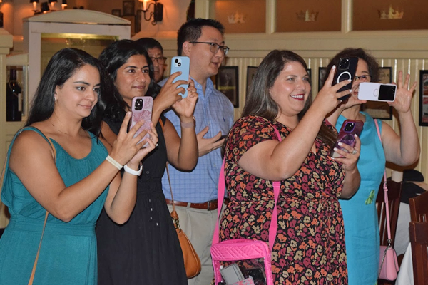 Family taking photos of the graduation with cell phones