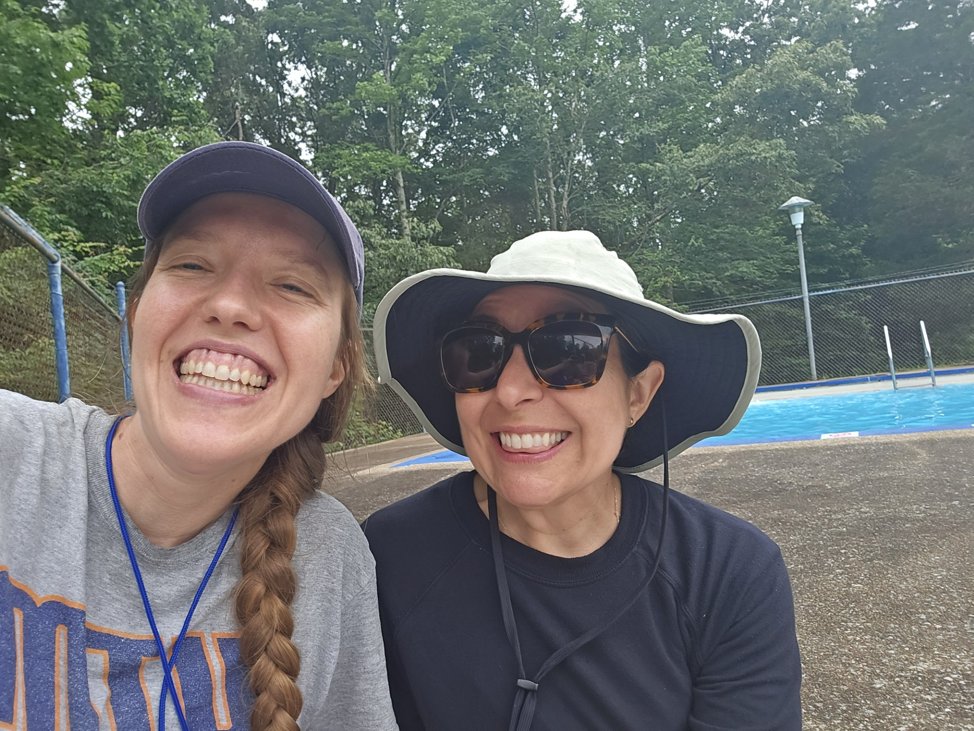 women smiling at camera with hats on