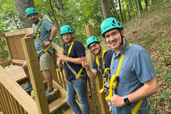 Group of residents on a ropes course with helmets and harnesses