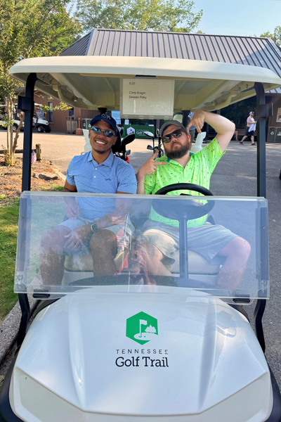 Residents riding in a golf cart