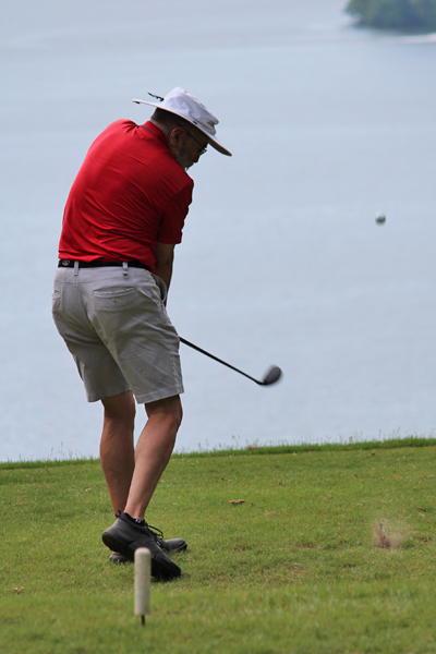 Male resident swinging a golf club