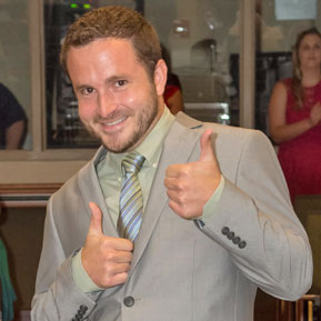 Graduate giving a thumbs up