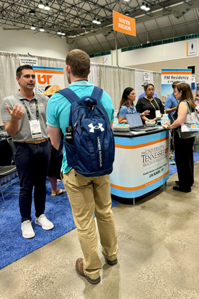 Faculty and residents at their booth on the conference floor