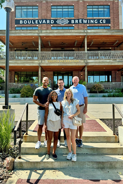 Faculty members and residents on stairs outside the Boulevard Brewing Co