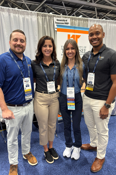 Residents and faculty in front of the Family Medicine booth