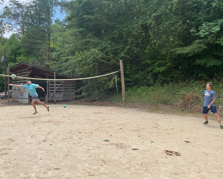 residents playing volleyball outside