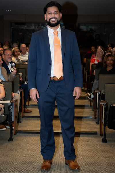 Male resident walking the aisle at graduation