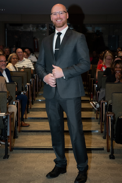 Male resident walking the aisle at graduation