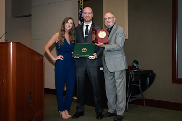 Faculty members with resident holding an award