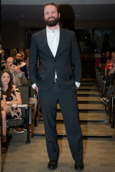 Male resident walking the aisle at graduation