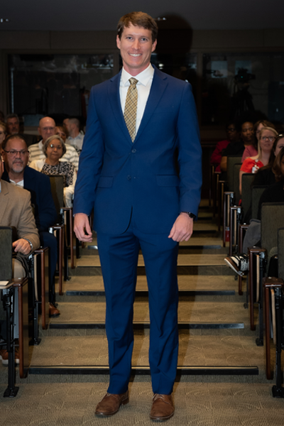 Male resident walking the aisle at graduation