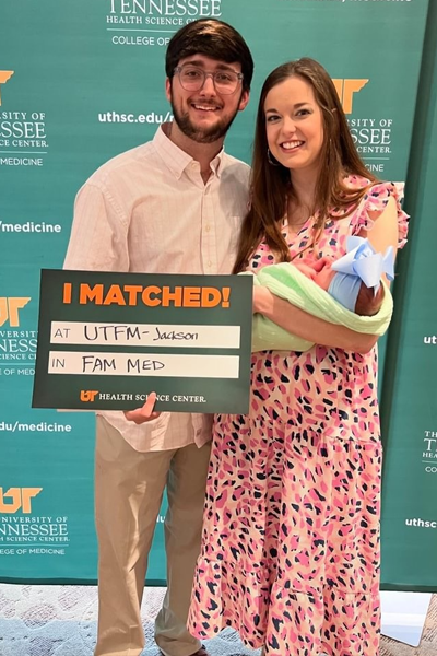 Resident and family with a matched sign for Jackson Family Medicine