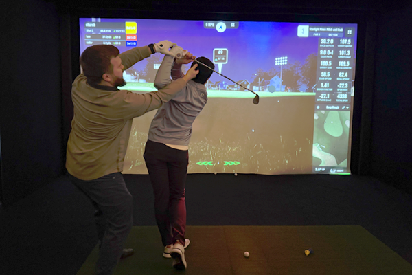 Residents playing virtual golf indoors