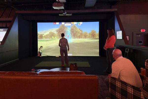 Residents playing virtual golf indoors