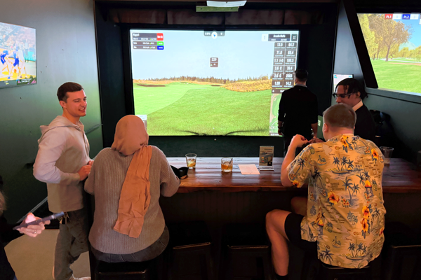 Residents playing virtual golf indoors