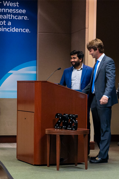 Residents at podium during graduation
