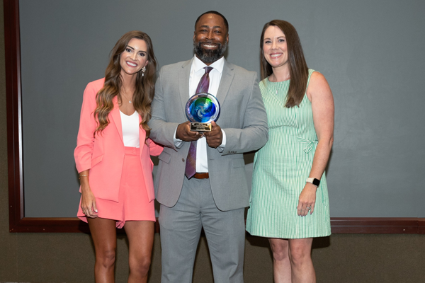 Faculty and resident with award at Graduation