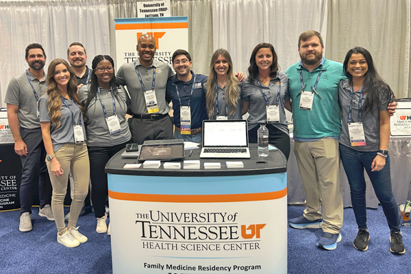 Faculty and residents in front of the family medicine booth