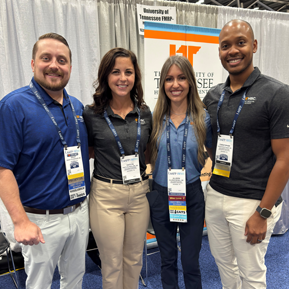 Residents and faculty inside the conference with colorful balloons in the background