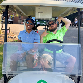 Residents in a golf cart