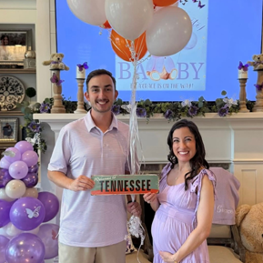 Resident and spouse holding a Tennessee sign to welcome new baby