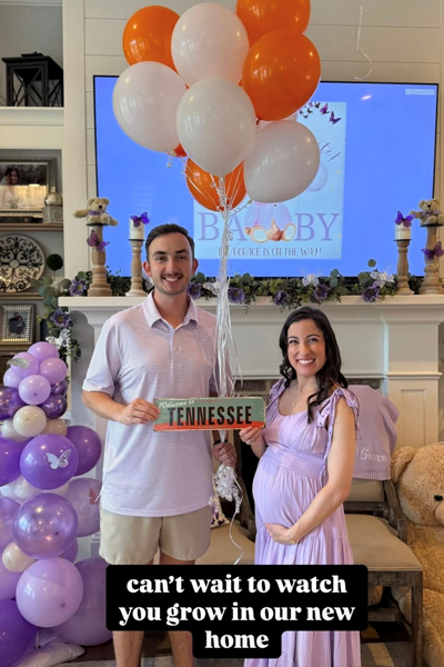 Resident and spouse holding a Tennessee sign to welcome new baby