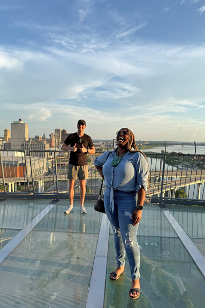 Two incoming residents taken on the balcony of the Bass Pro Pyramid with the city and river in the background