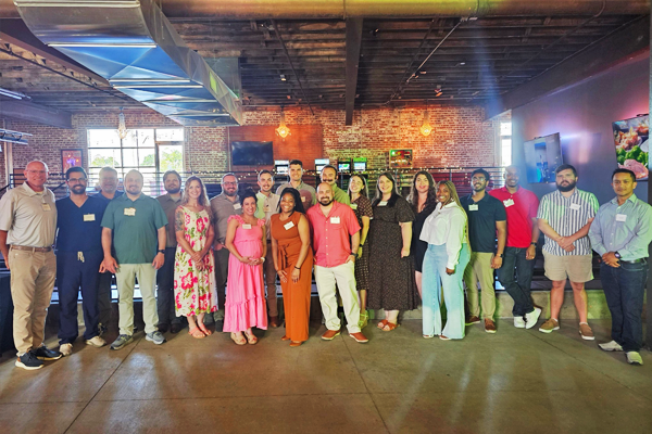 Group photo of incoming residents and faculty taken inside