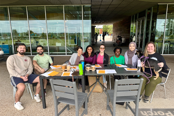 Group of residents sitting at a table outside