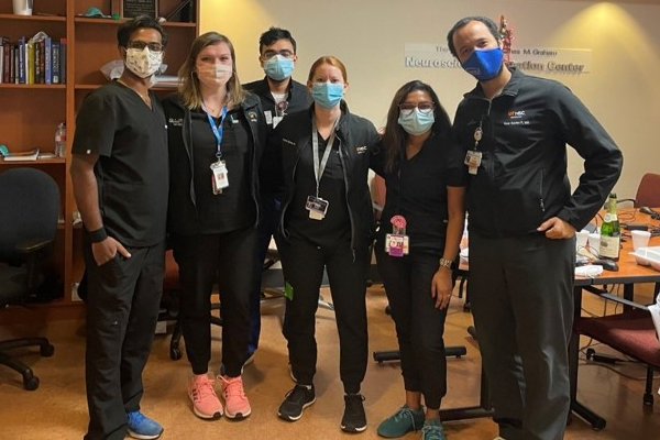 Fellows in black scrubs and masks