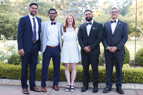 Faculty and fellows dressed up in an outdoor setting